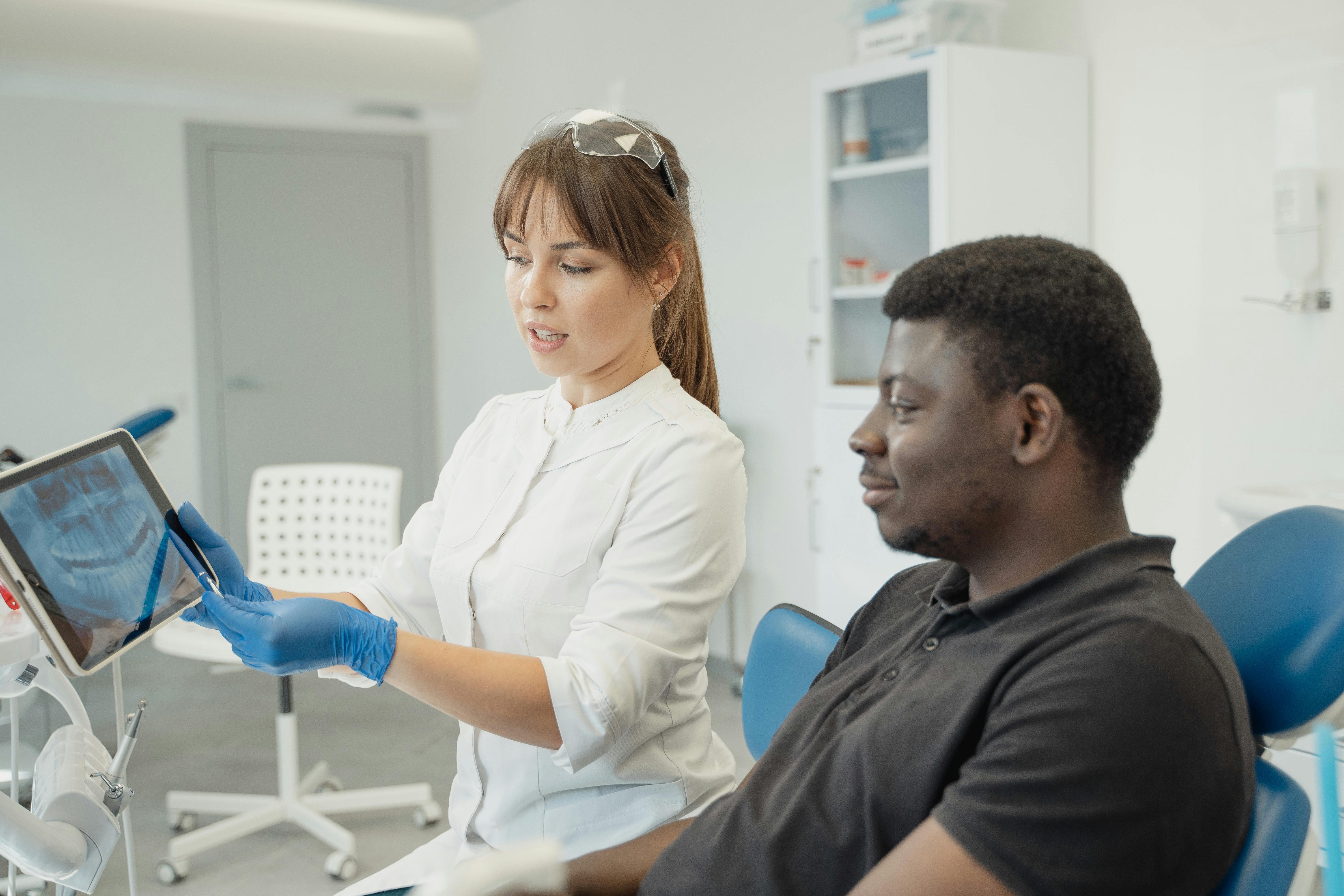 Dentist reviewing a dental scan with a seated patient